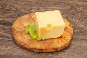 Emmental cheese over wooden board
