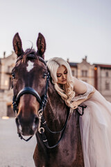 Obraz premium Beautiful woman with horse near castle