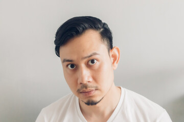 Fototapeta premium Asian man is checking out his new haircut after covid-19 quarantine.