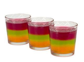 Three glasses with tricolor jelly isolated on white background