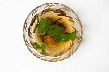 a preparation for a hot cup of ayurvedic medicine called kadha  with lot of herbs for safeguard...