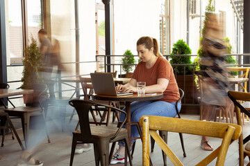 Remote co-working. Caucasian inclusive plus-size model in daily routine. Realness, tolerance. Her lifestyle is the same like of other people. Concept of wellness, inclusion, diversity, human rights.
