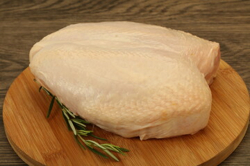 Raw whole chicken breast with skin