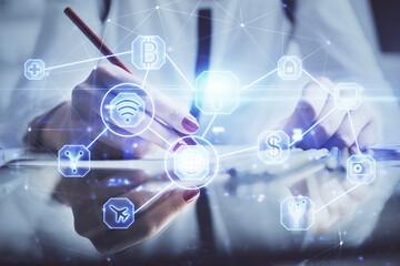 Social network theme hologram over hands taking notes background. Concept of global international people connect. Double exposure