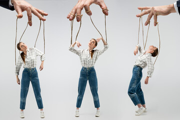 cropped view of puppeteer holding marionette on strings isolated on grey, collage - obrazy, fototapety, plakaty