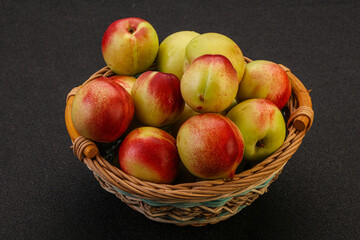 Sweet small nectarines in the basket