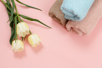 Soft terry towels with flowers on a pink background.