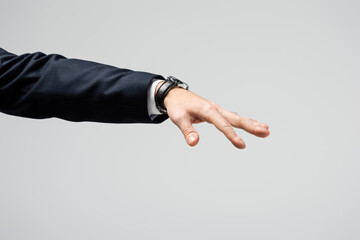 cropped view of businessman manipulating with hand isolated on grey