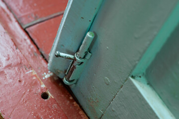 The lock of the wooden door is part of the powder. Old mechanical deadbolt for this door leaf