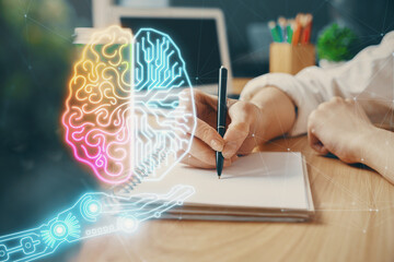 Multi exposure of writing hand on background with brain hologram. Concept of learning.