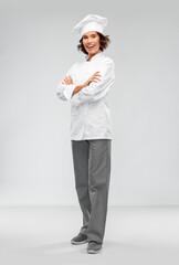 cooking, culinary and people concept - happy smiling female chef in toque over grey background
