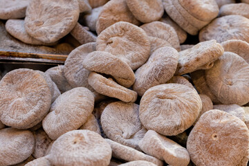 Pile of dried figs, coated in wheat flour, on a market stall