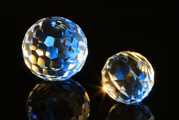 Faceted glass sphere on a black reflective surface