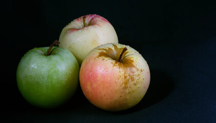 Ripe apples on a black background