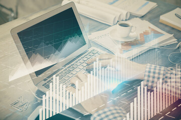 Double exposure of forex graph with man working on computer on background. Concept of market...