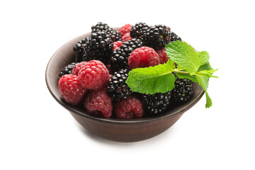 Raspberry, blackberry and mint leaf in ceramic brown bowl isolated on white