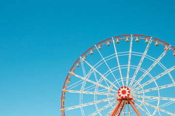 Ferris wheel against the blue sky. 