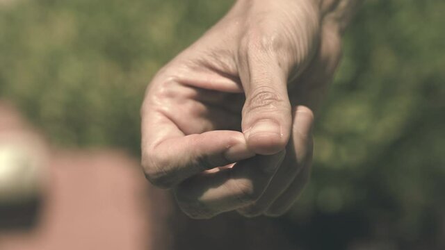 Close up of the hand of a woman who is nervously scratching a hangnail. Agitation concept.
