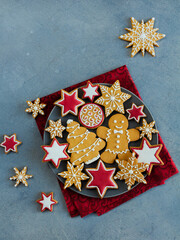 Christmas gingerbread cookies on plate on dark background with copy space for text. New year, Christmas holiday, greetings, celebration, decoration and baking concept.