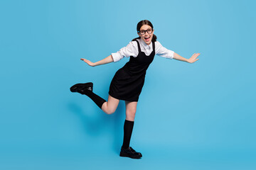 Fototapeta na wymiar Full length body size view of her she nice attractive lovely pretty cheerful cheery carefree schoolgirl having fun flying wings jet isolated over bright vivid shine vibrant blue color background