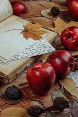 Autumn still life with red apples and nuts on an old iron background. The view from the top.