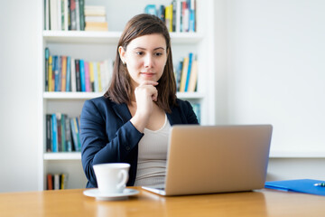 Caucasian businesswoman watching movie at computer