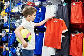 Boy with ball in football store