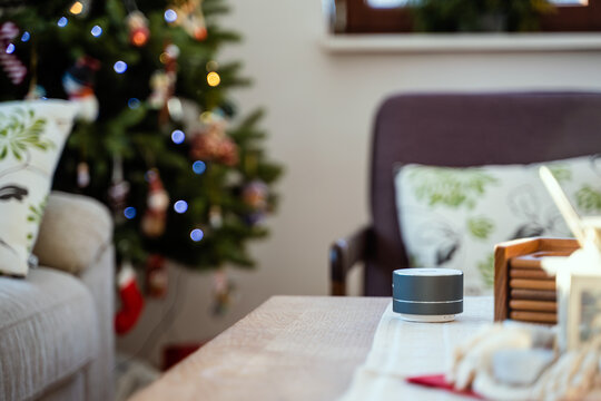 Smartvoice  Ai Speaker With Christmas Tree In Background. Smart Home Concept During Christmas Holiday Winter Time