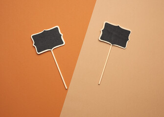 wooden pointer on a stick for writing text, brown background