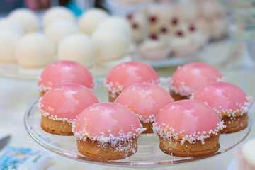 
Pink cakes on the festive table.Cupcakes on a plate