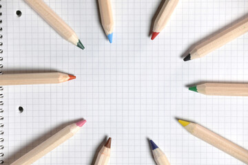 Flat lay view of white notebook , color pencils on a table. Preparing for a school. Back to school.