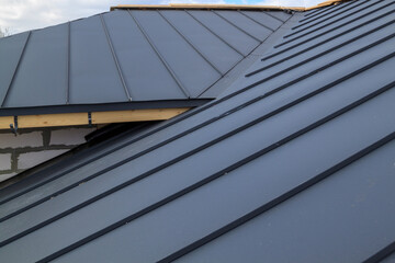 close up view of  house under construction with grey folding roof on waterproofing layer - obrazy, fototapety, plakaty