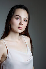 Portrait of woman in white blouse and black hair.