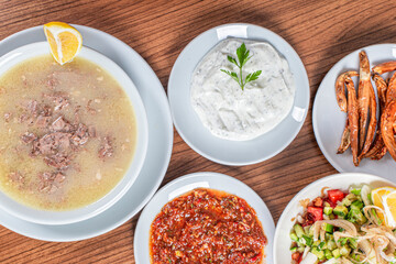 Turkish Traditional Soup with bread on white rustic wooden background, kelle, paca corbasi.
