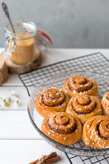 Freshly baked cinnamon buns with spices on a wooden background. Kanelbule - swedish dessert. Food concept. Rustic style