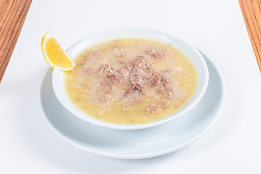Turkish Traditional Soup with bread on white rustic wooden background, kelle, paca corbasi.