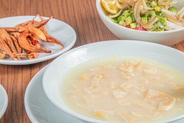 Turkish Traditional Soup with bread on white rustic wooden background, iskembe corbasi.