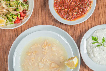 Turkish Traditional Soup with bread on white rustic wooden background, iskembe corbasi.