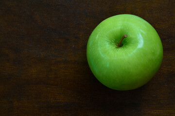 Green apple on wooden background