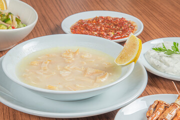 Turkish Traditional Soup with bread on white rustic wooden background, iskembe corbasi.