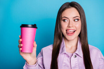 Closeup photo of charming lady hold hot takeaway beverage hands cheerful mood look tricky on mug...
