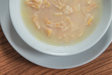 Turkish Traditional Soup with bread on white rustic wooden background, iskembe corbasi.