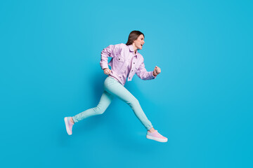Fototapeta na wymiar Full length profile photo of funny lady jumping high up running speed fast rushing shopping center sale wear casual denim violet jacket sweater pants shoes isolated blue color background