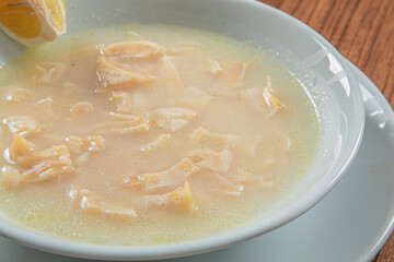 Turkish Traditional Soup with bread on white rustic wooden background, iskembe corbasi.