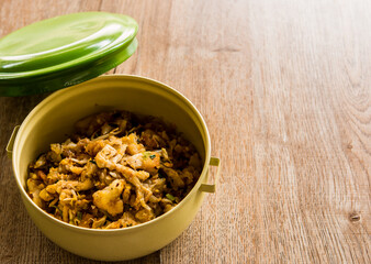 Fried chopped  chicken with noodles in food carrier , in door  Chiangmai  Thailand