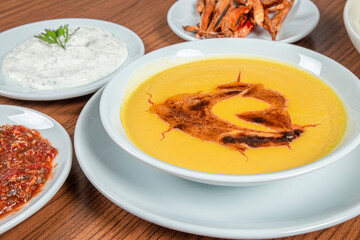 Turkish Traditional lentil Soup with bread on white rustic wooden background, mercimek corbasi.