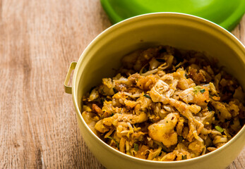 Fried chopped  chicken with noodles in food carrier , in door  Chiangmai  Thailand