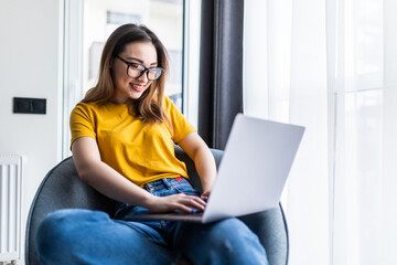 Young beautiful asian woman using laptop computer working online at home and feel relaxing on...