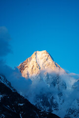 Snow peaks of mountains with blue sky and beautiful clouds. Winter tourism in Karakorum, Pakistan....