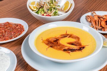 Turkish Traditional lentil Soup with bread on white rustic wooden background, mercimek corbasi.